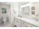 Clean bathroom with white cabinets, a white tile shower, and natural light from the window at 3501 Emperor Way, Tucker, GA 30084