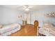 Spacious bedroom with hardwood floors, twin beds, a ceiling fan, and ample closet space at 3501 Emperor Way, Tucker, GA 30084