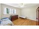Cozy bedroom with hardwood floors, twin beds, and a ceiling fan at 3501 Emperor Way, Tucker, GA 30084