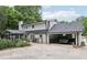 Rear exterior view showing the screened porch, garage, and lush landscaping at 3501 Emperor Way, Tucker, GA 30084
