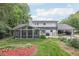 Back exterior of home with screened porch, attached garage and well manicured lawn at 3501 Emperor Way, Tucker, GA 30084