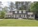Charming two-story house with gray siding, dormer windows, black shutters, mature trees, and a lush front lawn at 3501 Emperor Way, Tucker, GA 30084