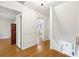 Bright hallway featuring hardwood floors, white walls and trim, offering views into other rooms at 3501 Emperor Way, Tucker, GA 30084