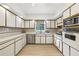 Functional kitchen boasting ample cabinet space, stainless steel appliances, and a garden view window at 3501 Emperor Way, Tucker, GA 30084