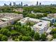 An aerial view showcases community with mature trees and easy access to Atlanta, as seen in the skyline at 870 Inman Village Pkwy # 203, Atlanta, GA 30307