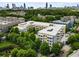 An aerial view showcases community with mature trees and easy access to Atlanta, as seen in the skyline at 870 Inman Village Pkwy # 203, Atlanta, GA 30307