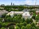 An aerial view showcases community with mature trees and easy access to Atlanta, as seen in the skyline at 870 Inman Village Pkwy # 203, Atlanta, GA 30307