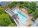 An aerial view showcases the pool and courtyard area in this community, surrounded by mature landscaping and green space at 870 Inman Village Pkwy # 203, Atlanta, GA 30307