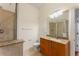 Bathroom featuring a glass-enclosed shower and a granite-topped vanity at 870 Inman Village Pkwy # 203, Atlanta, GA 30307