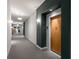 Hallway with carpet and white and dark-painted walls, with an apartment door at 870 Inman Village Pkwy # 203, Atlanta, GA 30307