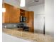 Granite counters and stainless steel appliances complement the wood cabinets in the well-appointed kitchen at 870 Inman Village Pkwy # 203, Atlanta, GA 30307