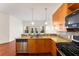 Open kitchen with granite countertops and stainless appliances with hardwood floors and natural light at 870 Inman Village Pkwy # 203, Atlanta, GA 30307
