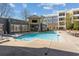 Relaxing pool area with surrounding patio, shade structures, and condo buildings at 870 Inman Village Pkwy # 203, Atlanta, GA 30307