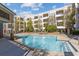 Community swimming pool and courtyard with seating areas, mature trees, and shade at 870 Inman Village Pkwy # 203, Atlanta, GA 30307