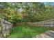 Well-kept backyard featuring a lawn enclosed by a wooden fence with mature trees in the background at 115 Benfield Cir, Cartersville, GA 30121