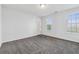 A spacious bedroom with carpeted flooring and natural light from the windows at 115 Benfield Cir, Cartersville, GA 30121