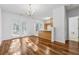 Open-concept dining area with hardwood floors, modern lighting, and access to the kitchen and backyard at 115 Benfield Cir, Cartersville, GA 30121