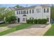 Inviting two-story townhome with black shutters, manicured landscaping, and a convenient two-car driveway at 115 Benfield Cir, Cartersville, GA 30121