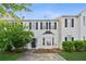 Charming two-story townhome featuring black shutters, a bay window and a well-manicured lawn at 115 Benfield Cir, Cartersville, GA 30121