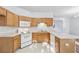 A well-equipped kitchen featuring wood cabinets and white appliances at 115 Benfield Cir, Cartersville, GA 30121
