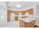 A spacious kitchen with wood cabinets, white appliances and tiled floor at 115 Benfield Cir, Cartersville, GA 30121