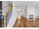 Bright living room featuring hardwood floors, a decorative fireplace and an adjacent staircase at 115 Benfield Cir, Cartersville, GA 30121