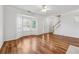 Inviting living room with hardwood floors, white trim, a bay window and an adjacent staircase at 115 Benfield Cir, Cartersville, GA 30121