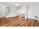 Open-concept living room featuring hardwood floors, white trim, a ceiling fan and an adjacent staircase at 115 Benfield Cir, Cartersville, GA 30121