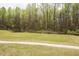 Spacious, well-manicured backyard featuring a lush lawn and wooded backdrop that provides privacy at 118 Jasmine Way, Carrollton, GA 30180