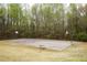 Outdoor basketball court featuring two hoops and a bench, surrounded by trees and green space at 118 Jasmine Way, Carrollton, GA 30180