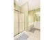 Bathroom featuring a walk-in shower, bathtub, tiled flooring, and light fixtures at 118 Jasmine Way, Carrollton, GA 30180