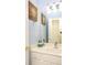 Bathroom vanity with whale decor, bright lighting, mirror and nautical themed compass wall art at 118 Jasmine Way, Carrollton, GA 30180