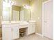 Bathroom featuring double vanity, mirror, ample lighting, and tiled flooring at 118 Jasmine Way, Carrollton, GA 30180