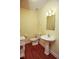 Half bathroom features hardwood floors, a pedestal sink, and a classic toilet at 118 Jasmine Way, Carrollton, GA 30180
