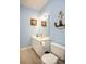 Nautical themed bathroom with vanity sink, toilet and compass and anchor wall art at 118 Jasmine Way, Carrollton, GA 30180