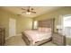 Spacious bedroom with tray ceilings, ceiling fan, and large bed with decorative pillows at 118 Jasmine Way, Carrollton, GA 30180