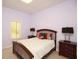 Charming bedroom featuring a well-lit window, wood furniture, and crisp bedding at 118 Jasmine Way, Carrollton, GA 30180