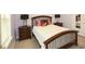 Comfortable bedroom with a white bed, a wood headboard, and two matching bedside tables at 118 Jasmine Way, Carrollton, GA 30180