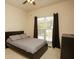 Neutral bedroom with a window, dark curtains, and a sleek bed at 118 Jasmine Way, Carrollton, GA 30180