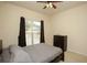 Neutral bedroom with a window, dark curtains, and a dresser at 118 Jasmine Way, Carrollton, GA 30180