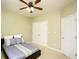 Bright bedroom with a ceiling fan and neutral carpet and a double door closet at 118 Jasmine Way, Carrollton, GA 30180