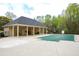View of the neighborhood pool with a protective cover, an adjacent cabana, and lounging area at 118 Jasmine Way, Carrollton, GA 30180