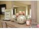 Decor atop a wood dresser which includes a mirror, clock, spheres, and candles at 118 Jasmine Way, Carrollton, GA 30180
