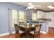 Bright dining area showcases hardwood floors and calming blue walls at 118 Jasmine Way, Carrollton, GA 30180