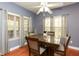 Bright dining area showcases hardwood floors and calming blue walls at 118 Jasmine Way, Carrollton, GA 30180
