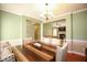 Dining room with hardwood floors, chandelier, and view into living room at 118 Jasmine Way, Carrollton, GA 30180