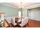 Cozy dining room with hardwood floors and view of front entrance at 118 Jasmine Way, Carrollton, GA 30180