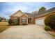 Brick home with a multi-car garage and long driveway provides ample parking at 118 Jasmine Way, Carrollton, GA 30180