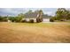 Residential home with mature landscaping, a grassy lawn and an attached garage at 118 Jasmine Way, Carrollton, GA 30180