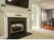 Elegant fireplace with white mantle, decorative accents, and an open view to other rooms at 118 Jasmine Way, Carrollton, GA 30180